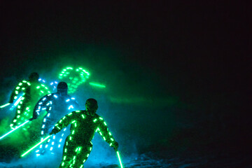 Obraz na płótnie Canvas skier with a glowing light suit at the ski show