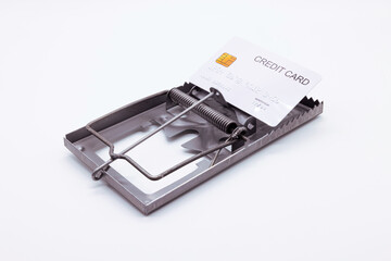 White credit card placed on a mousetrap, Financial trap, Indebtedness, Financial problems.