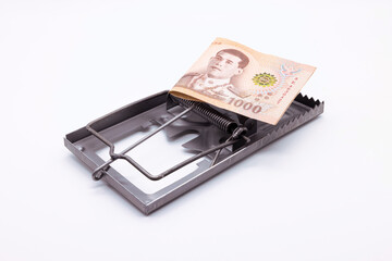 Thailand's 1,000 baht banknote placed on a mousetrap, Financial trap.