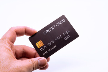 Hand holding a credit card, isolated on white background.