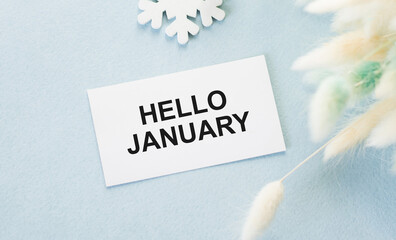 Hello January text on a card on a blue background
