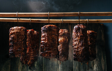 Hanging ham in the smokehouse smoked bacon for smoking. Traditional method of smoking meat in smok in a homemade smokehouse © Надія Коваль
