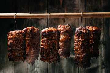 Sliced smoked gammon on a black background. Natural product from an organic farm, produced by...