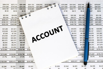 An open notebook on which the word account is written. A table with numbers and a pen. Business and...