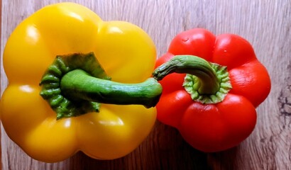 Yellow and red peppers on a wooden board