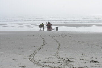 Couple fishing in the ocean surf