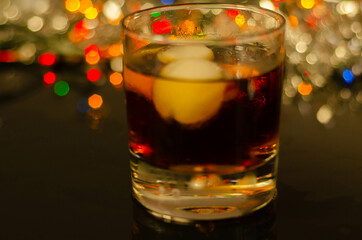 Drink Cuba Libre, rum with cola in an old fashoned glass with two ice balls