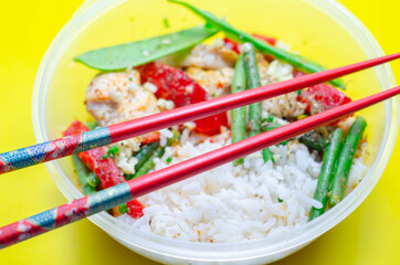 Cooked chicken breast pieces in a red Thai curry sauce made with coconut cream, red chillies, lemongrass, lime leaf, with fragrant rice, red peppers, mangetout, and green beans