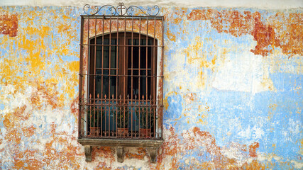 old window with cage and multicolor wall 