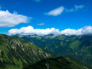 Obraz premium Idyllic landscape in the austrian Alps with a view of pine trees on the hills. Mountain peaks in the background. Tannheimer Tal, Austria