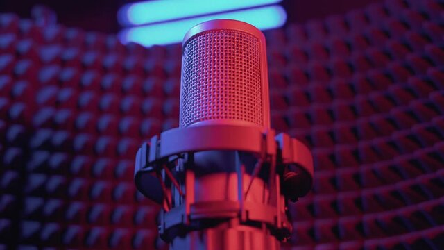 Studio microphone for recording vocals and musical instruments with a large membrane. Professional studio equipment. Acoustic screen made of foam rubber and horizontal lights on the background.