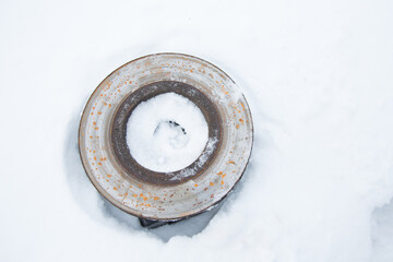 Old rusty brake disc is on snow. Concept disc corrosion - 477872189