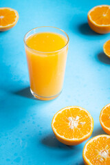 A Glass of Orange Juice with a Summer Blue Background.