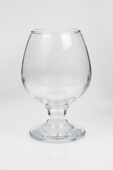 empty glass goblet for cognac on white background