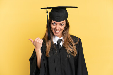 Young university graduate isolated on yellow background pointing to the side to present a product