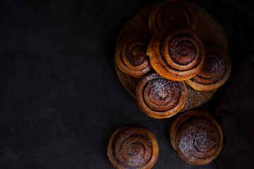 Homemade buns with cinnamon and powdered sugar, homemade pastries, top view