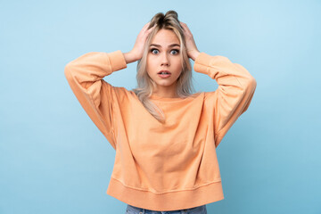 Teenager girl over isolated blue background with surprise facial expression