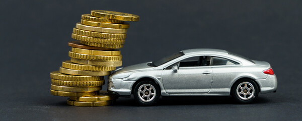 Insurance concept. The toy car crashed into coins.