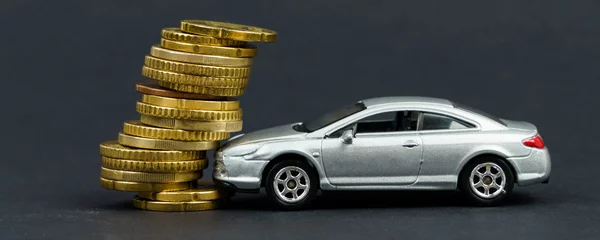 Fotobehang Insurance concept. The toy car crashed into coins. © Dzmitry