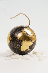Near the black-and-gold globe, in the form of a bomb - covered by a pandemic, there are medicines