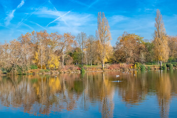 The Vincennes lake, with reflection of the trees in autumn