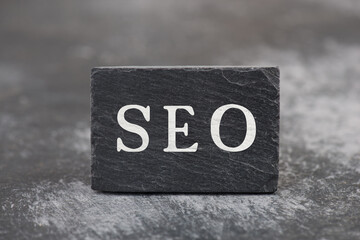 The word SEO is standing on a black colored background, website optimization, ranking strategy