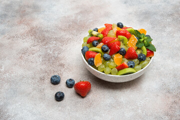 Fruit salad of blueberries, strawberries, grapes and kiwi in a plate