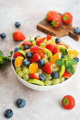 Fruit salad of blueberries, strawberries, grapes and kiwi in a plate
