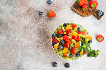 Fruit salad of blueberries, strawberries, grapes and kiwi in a plate