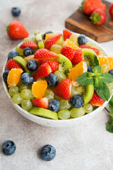 Fruit salad of blueberries, strawberries, grapes and kiwi in a plate