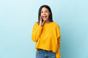 Caucasian girl isolated on blue background with surprise and shocked facial expression