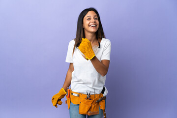 Young electrician woman isolated on purple background celebrating a victory