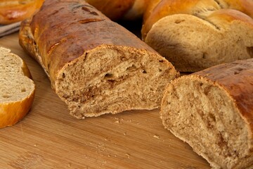 Bread in the shape of a braid. Sweet Challah. Slice of banana bread for breakfast, side view. Cherry tomatoes . High quality photo