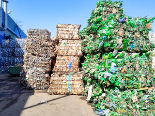 Recycled plastic bottles in bales at a recycling facility.