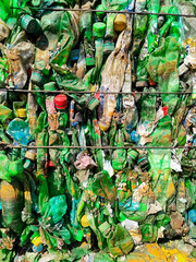 Recycled plastic bottles in bales at a recycling facility.