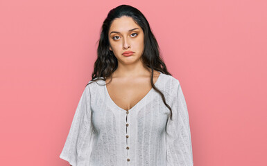 Fototapeta premium Brunette young woman wearing casual clothes depressed and worry for distress, crying angry and afraid. sad expression.