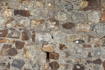 Antiguo muro de piedra gris, al aire libre
