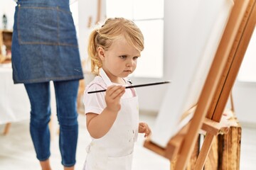 Mother and daughter concentrate drawing at art studio