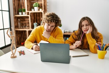 Young caucasian couple having online art class at home