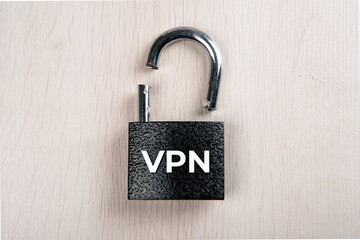 broken padlock with inscription VPN on a wooden background