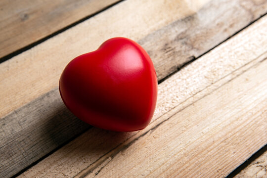 Large red heart on wooden background close up