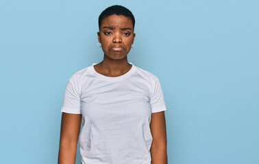 Young african american woman wearing casual white t shirt depressed and worry for distress, crying angry and afraid. sad expression.