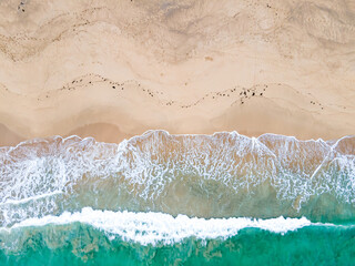 Aerial View of a beach with turquoise waves