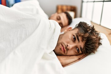 Fototapeta na wymiar Two hispanic men couple sleeping at bedroom