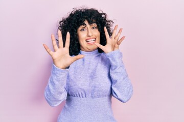 Young middle east woman wearing casual clothes afraid and terrified with fear expression stop gesture with hands, shouting in shock. panic concept.