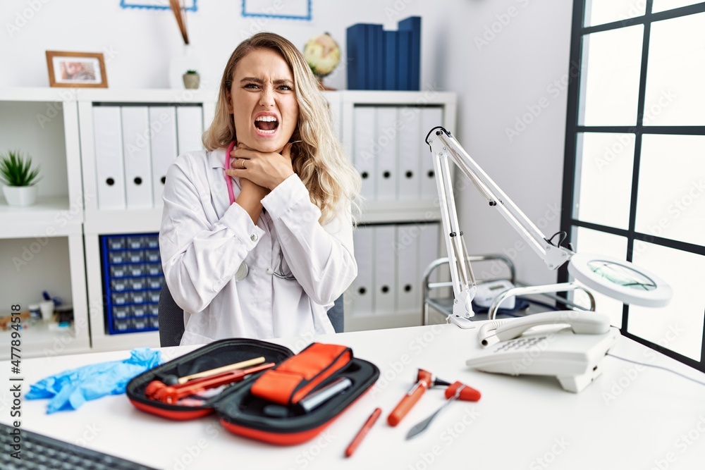 Poster young beautiful doctor woman with reflex hammer and medical instruments shouting and suffocate becau