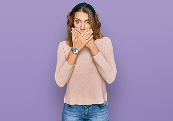 Beautiful young caucasian woman wearing casual sweater shocked covering mouth with hands for mistake. secret concept.