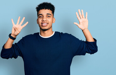 Young african american man wearing casual clothes showing and pointing up with fingers number nine...