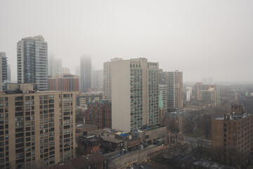 Fototapeta premium Panoramic Urban City View of a Metropolitan City during Misty and Cloudy Weather