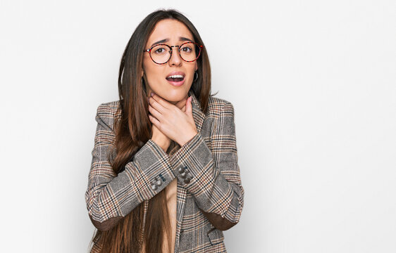 Young hispanic girl wearing business clothes and glasses shouting and suffocate because painful strangle. health problem. asphyxiate and suicide concept.